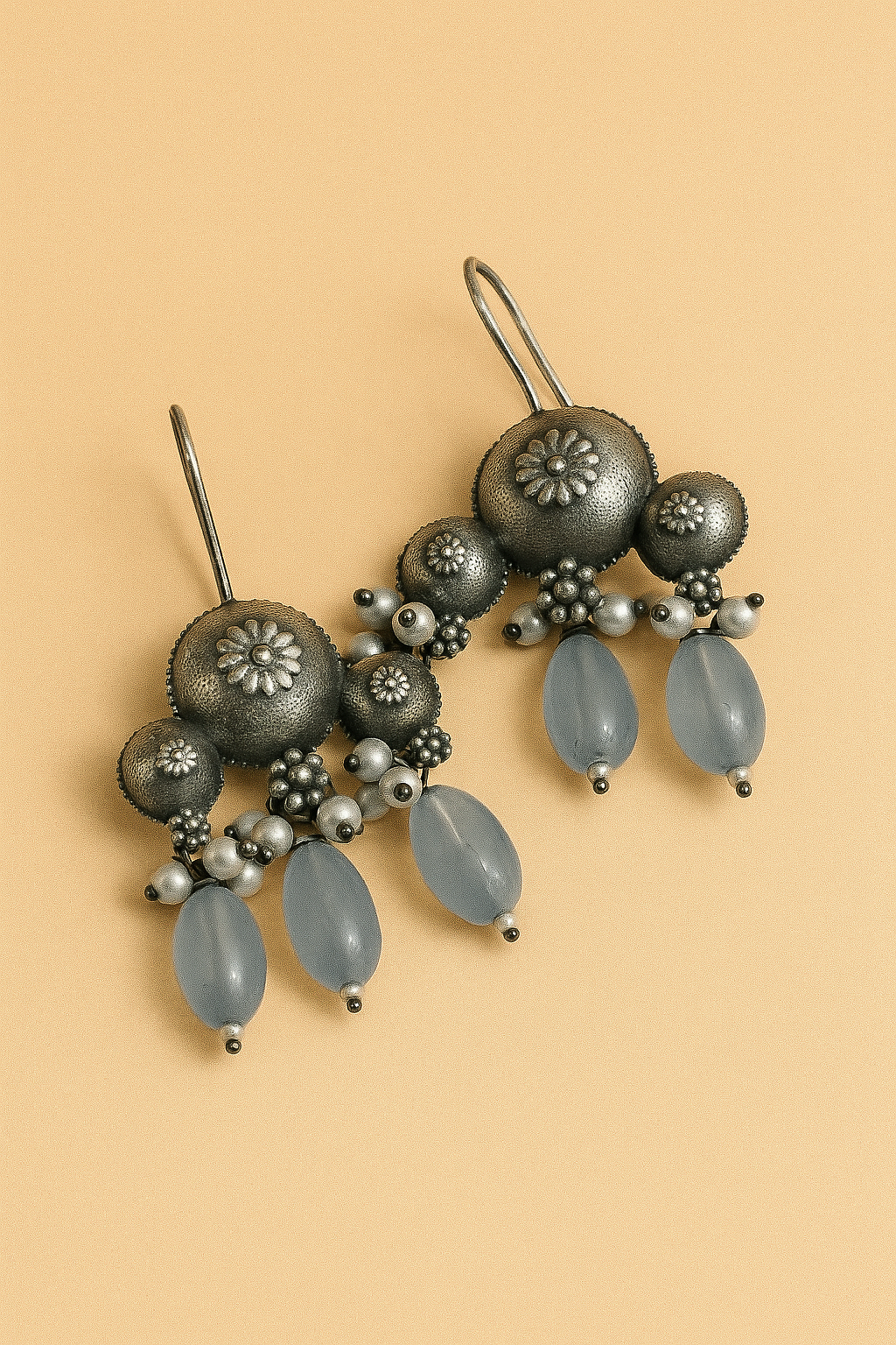 Decorative hairpin with gray beads and floral designs on a beige background