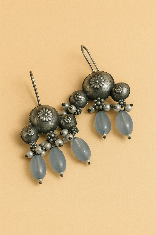 Decorative hairpin with gray beads and floral designs on a beige background